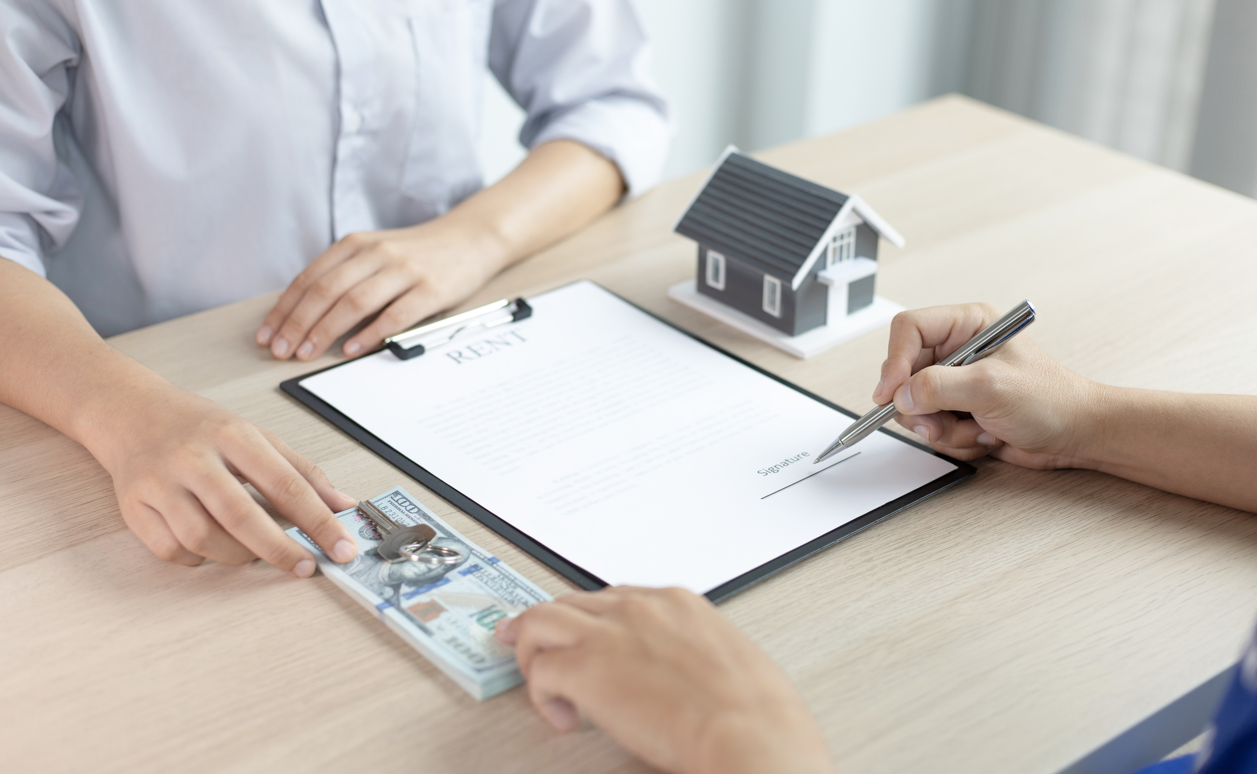 Real Estate Agent Showing Rent Contract to Client